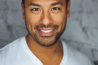 A person looking thoughtfully at documents